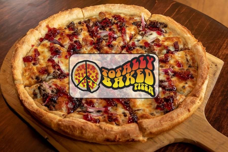 Gourmet pizza with cheese, onions, and sauce from Totally Baked Pizza in Akron Ohio